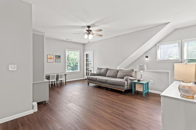 living room featuring a wealth of natural light, ceiling fan, dark hardwood / wood-style floors, and lofted ceiling