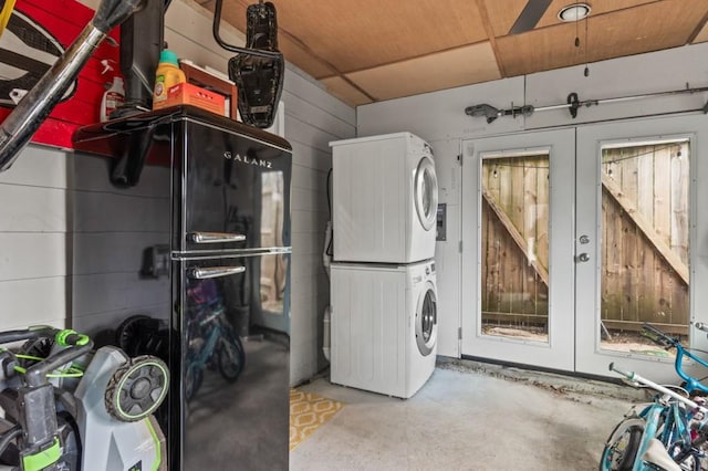 washroom featuring stacked washing maching and dryer and french doors