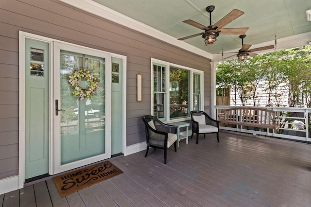 wooden terrace featuring ceiling fan