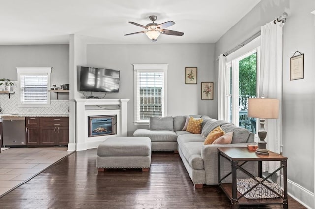 living room featuring ceiling fan and dark hardwood / wood-style floors