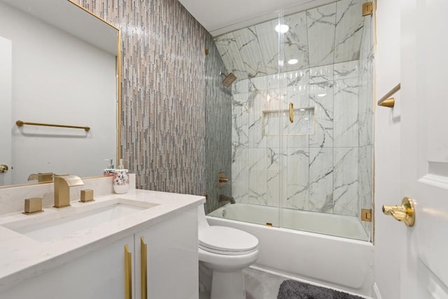 full bathroom with toilet, vanity, and combined bath / shower with glass door