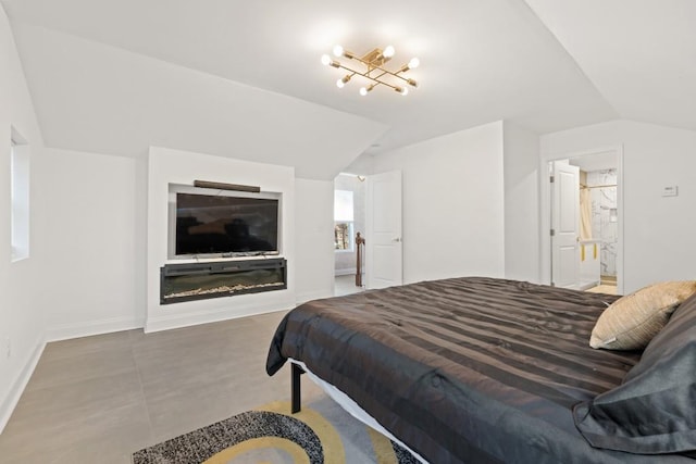 bedroom featuring connected bathroom and lofted ceiling