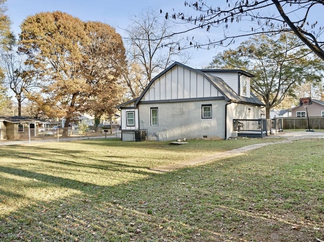 view of side of home featuring a lawn