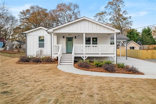 view of front of home featuring covered porch and a front yard