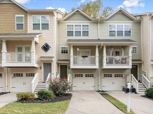 view of property with a balcony and a garage