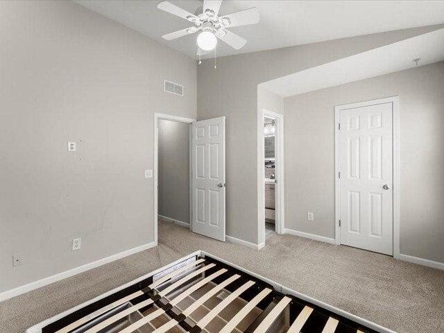 unfurnished bedroom with lofted ceiling, light colored carpet, and ceiling fan