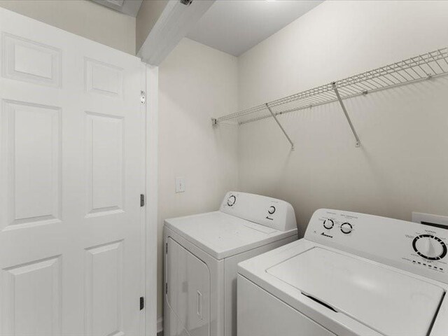 clothes washing area with washer and dryer