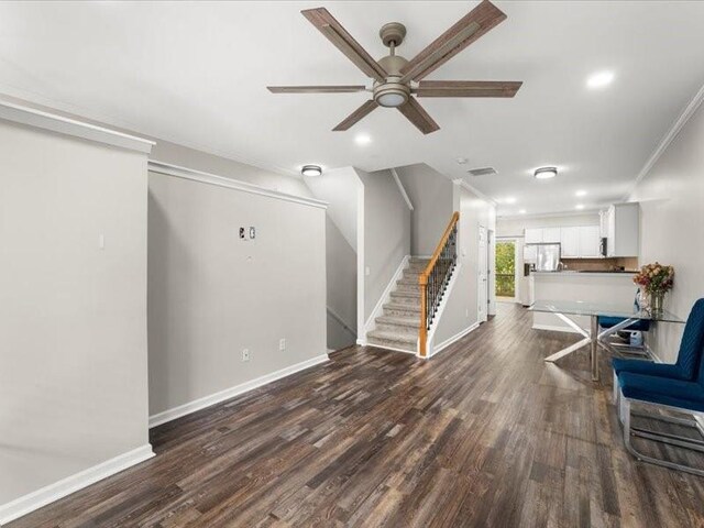 living room with ceiling fan, dark hardwood / wood-style floors, and ornamental molding