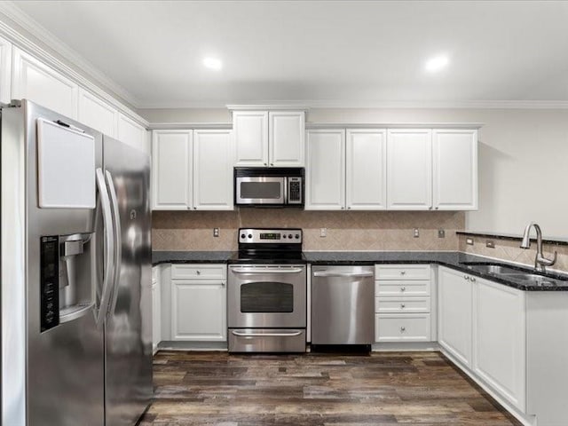 kitchen featuring stainless steel appliances, dark hardwood / wood-style floors, white cabinets, and sink