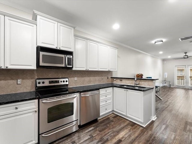 kitchen featuring white cabinets, stainless steel appliances, dark hardwood / wood-style floors, and sink