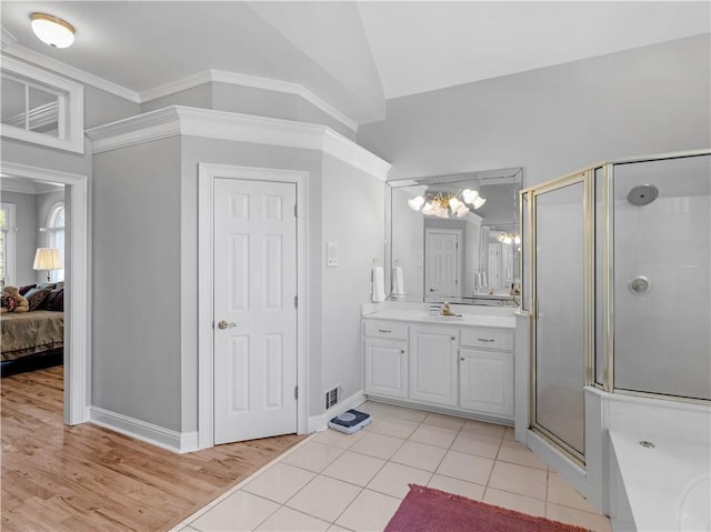 ensuite bathroom featuring connected bathroom, an inviting chandelier, visible vents, and a stall shower