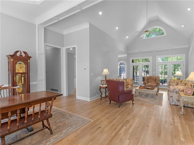 living area featuring visible vents, a ceiling fan, french doors, light wood-style floors, and high vaulted ceiling