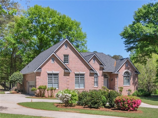 view of front facade with concrete driveway and brick siding