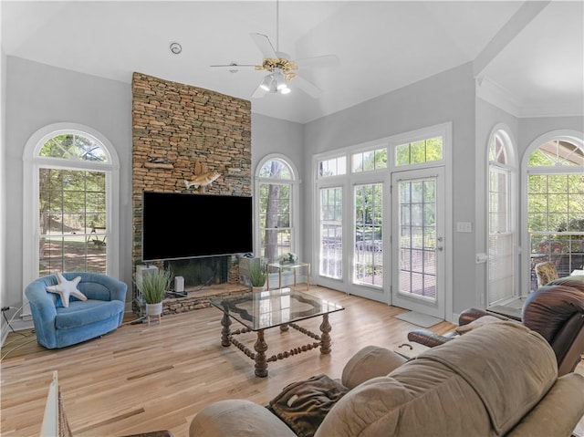 living room featuring wood finished floors, a towering ceiling, and ceiling fan