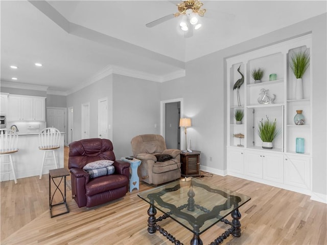 living area with recessed lighting, light wood finished floors, ornamental molding, baseboards, and ceiling fan