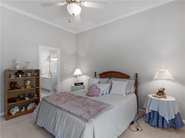 bedroom featuring ensuite bathroom, baseboards, light colored carpet, ceiling fan, and crown molding