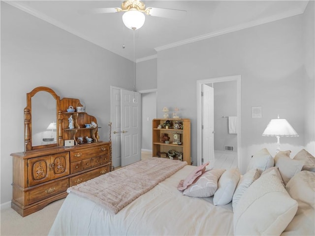 carpeted bedroom featuring visible vents, a ceiling fan, ornamental molding, connected bathroom, and baseboards