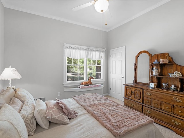 carpeted bedroom featuring crown molding and ceiling fan