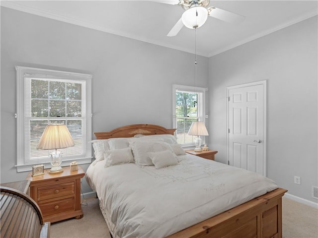 bedroom featuring ceiling fan, light carpet, ornamental molding, and baseboards