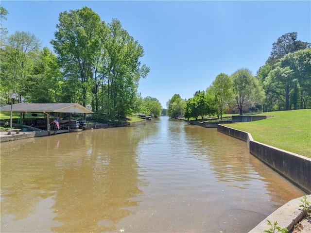 dock area featuring a yard and a water view
