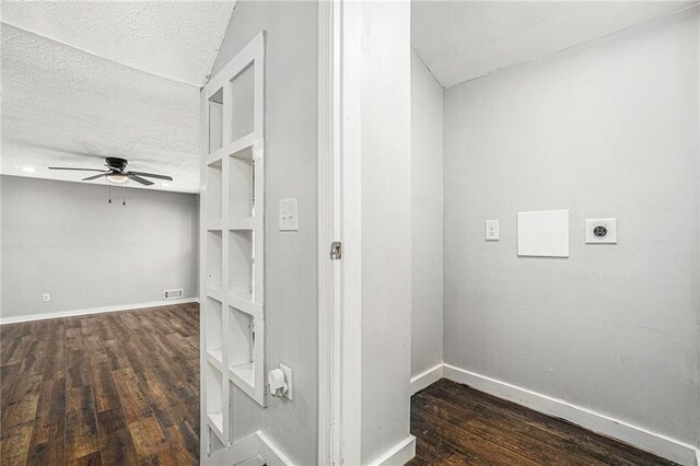 interior space featuring visible vents, a textured ceiling, baseboards, and dark wood-style flooring