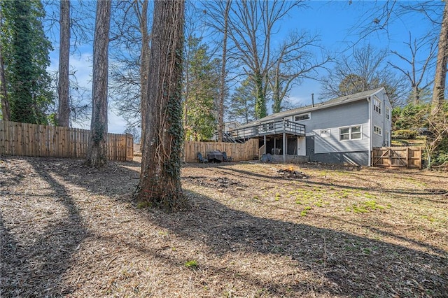 view of yard featuring a fenced backyard and a deck