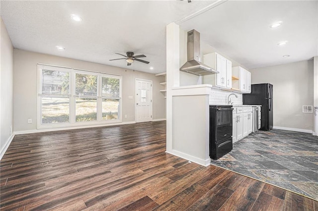 kitchen featuring light countertops, white cabinetry, black appliances, and exhaust hood