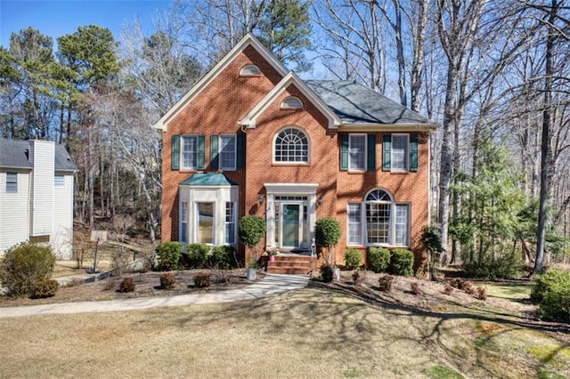 colonial home featuring brick siding