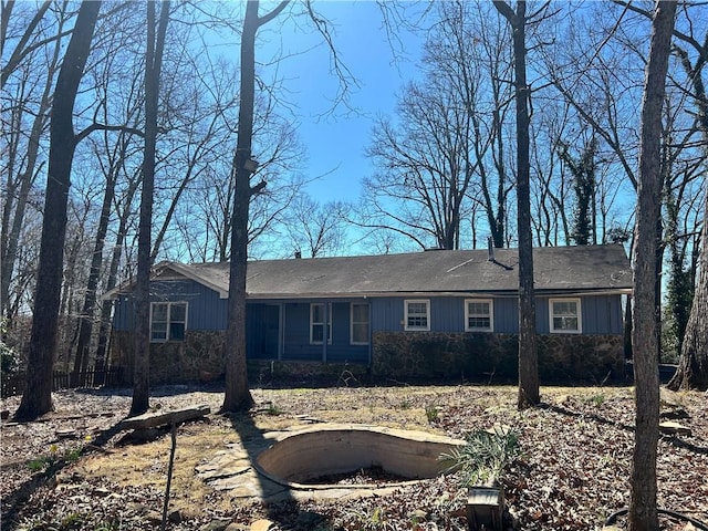 view of front of house featuring board and batten siding and stone siding