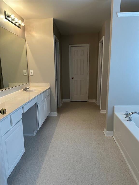 bathroom featuring vanity and a washtub