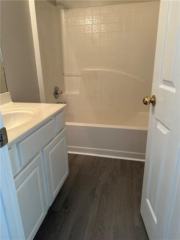 bathroom with vanity, hardwood / wood-style floors, and tub / shower combination