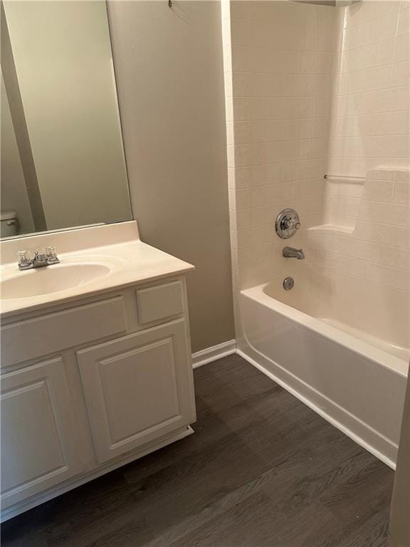 full bathroom with vanity, toilet, bathing tub / shower combination, and hardwood / wood-style floors