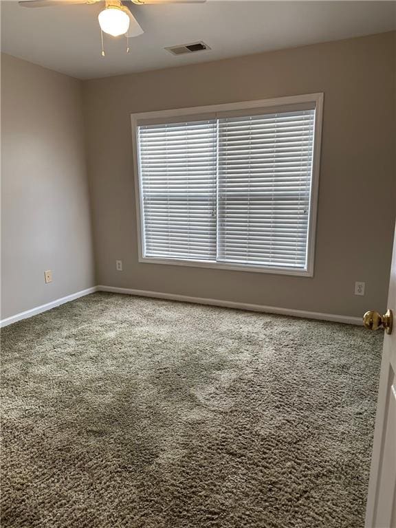 spare room with carpet and ceiling fan