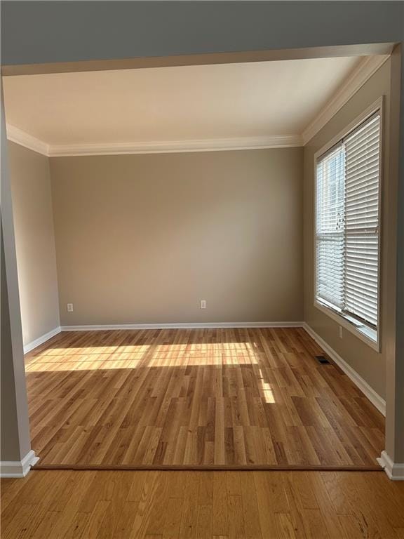 unfurnished room featuring crown molding and light hardwood / wood-style flooring