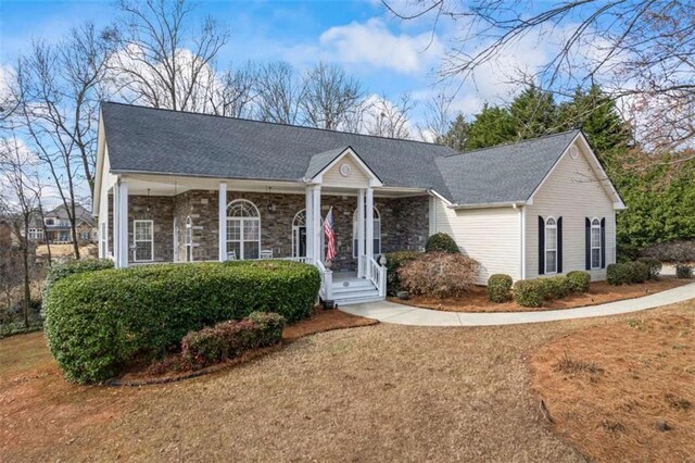 ranch-style house with covered porch and a front lawn