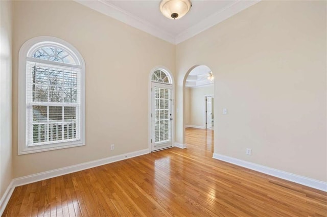 unfurnished room featuring ornamental molding and light wood-type flooring