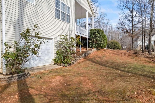 view of property exterior featuring a garage and a yard