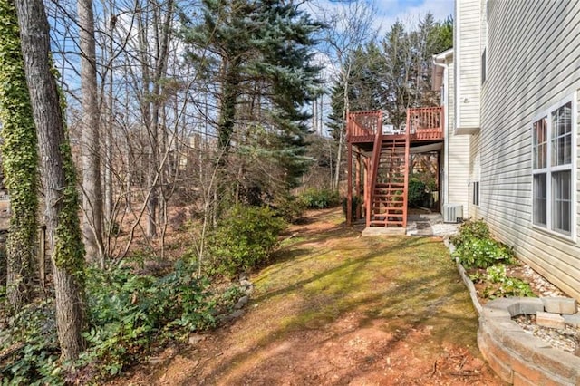 view of yard featuring a wooden deck and cooling unit