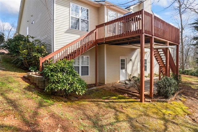 back of property featuring a yard and a deck