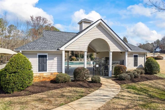 view of front facade featuring a fenced in pool, a patio, and a front yard