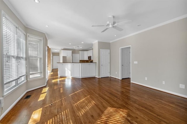 unfurnished living room with ornamental molding, ceiling fan, and dark hardwood / wood-style flooring