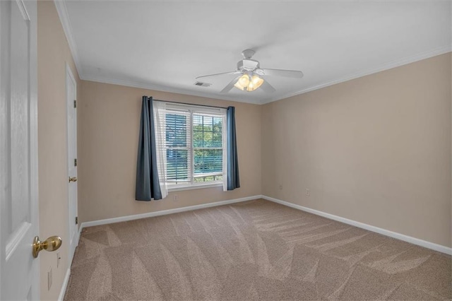 carpeted empty room with ceiling fan and ornamental molding