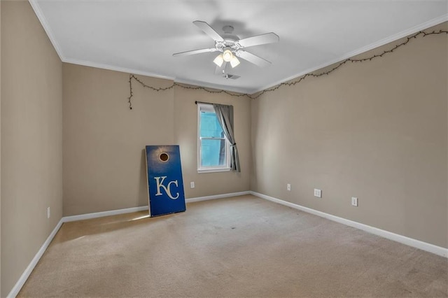 carpeted empty room featuring crown molding and ceiling fan