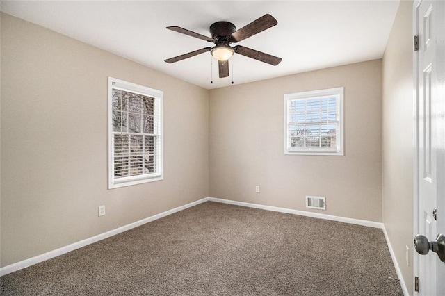 unfurnished room with a ceiling fan, carpet flooring, visible vents, and baseboards