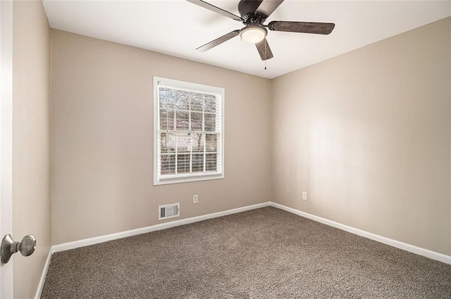 spare room featuring carpet floors, baseboards, visible vents, and ceiling fan