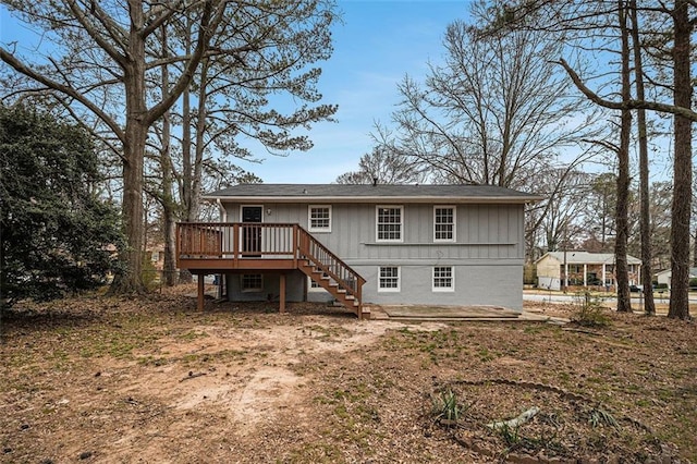 rear view of property featuring stairs and a deck