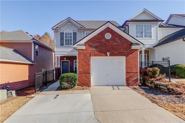 traditional-style home with brick siding, fence, driveway, and an attached garage