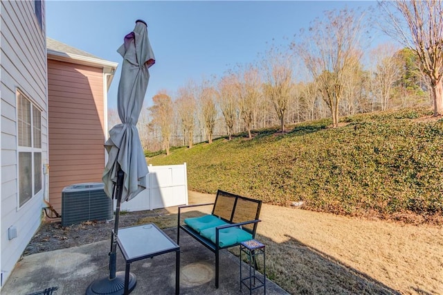 view of patio with fence and cooling unit