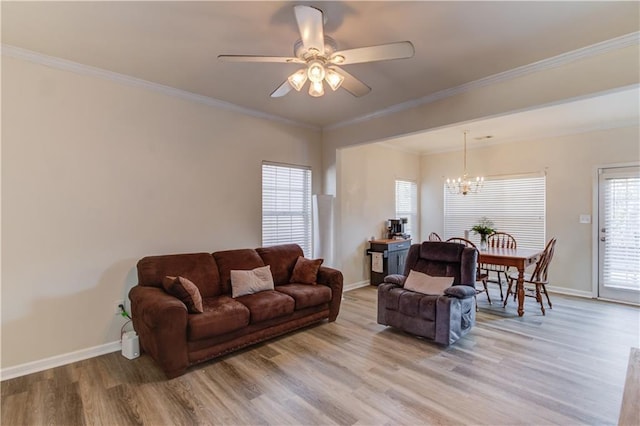 living room featuring ornamental molding, light wood-style flooring, and baseboards