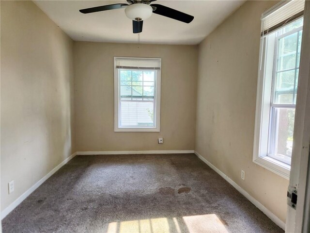 carpeted empty room featuring ceiling fan